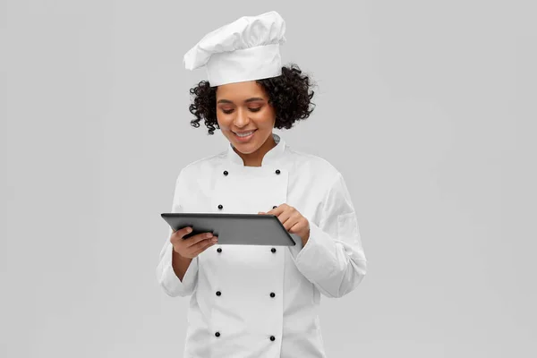 smiling female chef with tablet computer