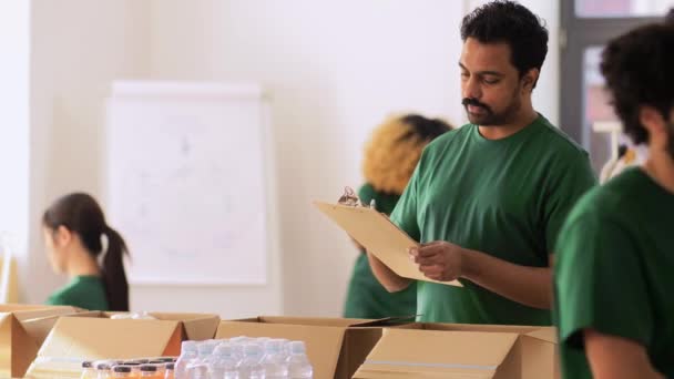 在捐赠箱中包装食物的一组志愿者 — 图库视频影像