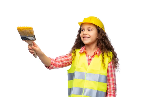 Chica en casco y chaleco de seguridad con pincel — Foto de Stock