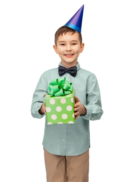 Menino sorridente em chapéu de festa com presente de aniversário — Fotografia de Stock