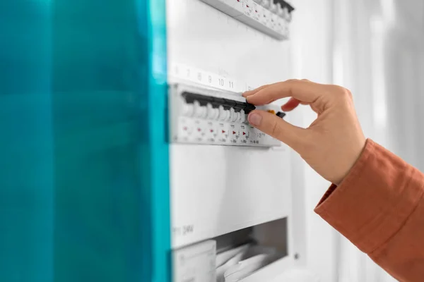 Close up of hand switching electric board at home — Stock fotografie