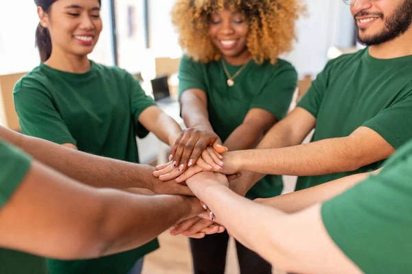 Close up of volunteers stacking hands — Stock Photo, Image