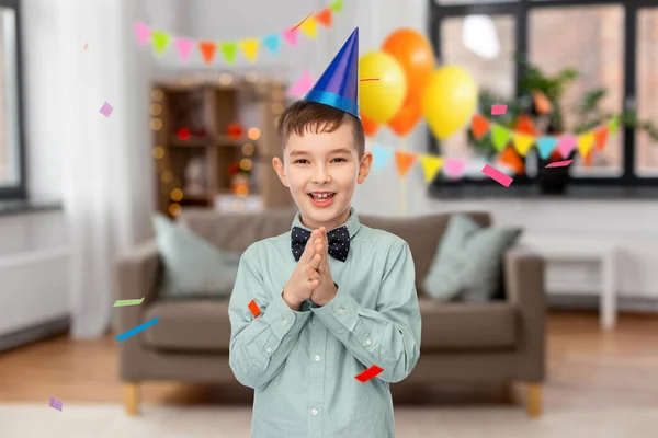 Sorrindo menino em aniversário festa chapéu batendo palmas — Fotografia de Stock