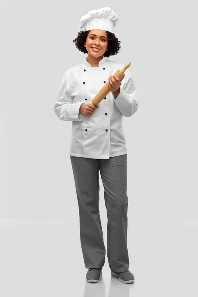 Souriant femme chef ou boulanger avec rouleau à pâtisserie — Photo