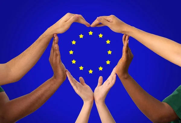 Hands make heart gesture over european union flag — стоковое фото
