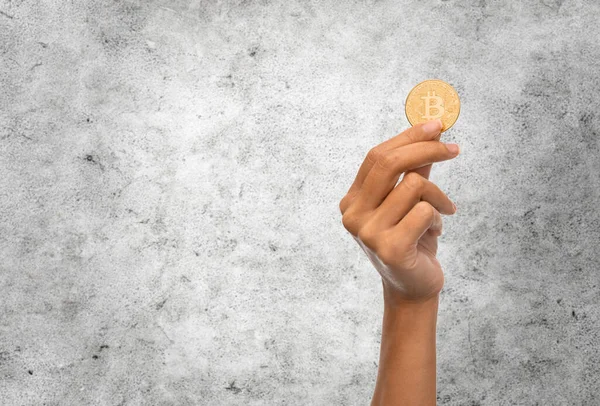 Close up of hand with bitcoin over white — Stock Photo, Image