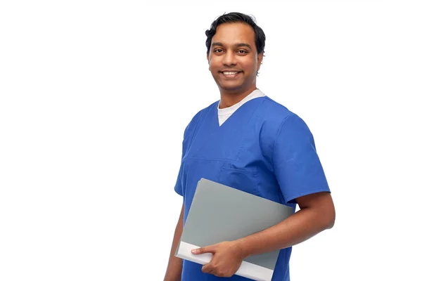 Happy indian doctor or male nurse with folder — Foto de Stock