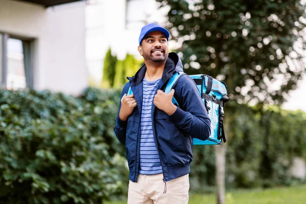 Indian delivery man with bag walking outdoors — Stock Photo, Image