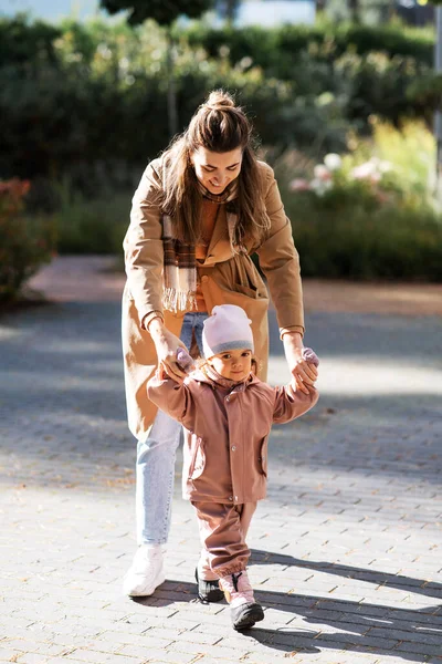 Happy mother walking with baby daughter outdoors — Stok fotoğraf