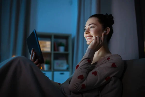 Tizenéves lány tabletta pc és fülhallgató az ágyban — Stock Fotó