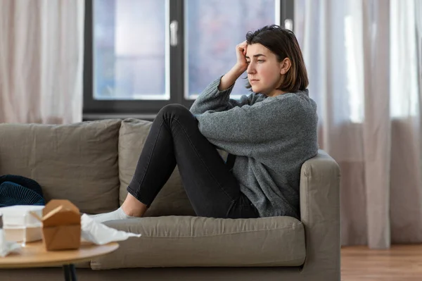 Stressed woman sitting on sofa at home — Stock Photo, Image