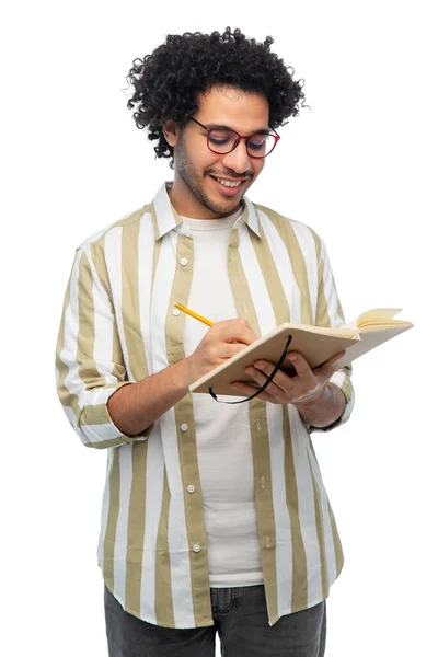 Happy smiling young man with diary and pencil — Foto Stock