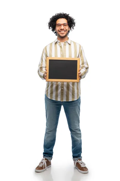 Smiling man with chalkboard over white background — Stok fotoğraf
