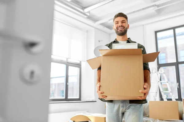 Happy man with box moving to new home — Stock Photo, Image