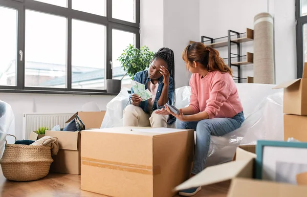 women moving to new home and counting money