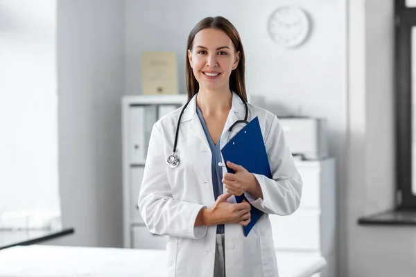 Doctora sonriente con portapapeles en el hospital — Foto de Stock