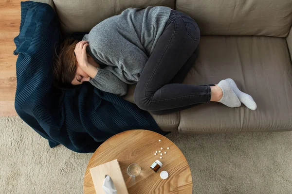 Depressed woman lying on sofa at home — Stock Photo, Image