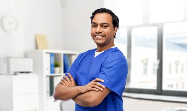 Szczęśliwy lekarz lub pielęgniarka mężczyzna w niebieskim mundurze — Zdjęcie stockowe