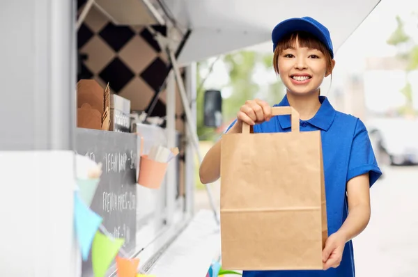 Delivery woman with takeaway food in paper bag — Stock Photo, Image