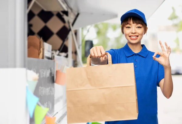 Delivery woman with paper bag showing ok sign — Foto de Stock