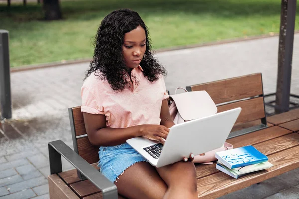 African student girl with laptop and books in city — Stock Photo, Image