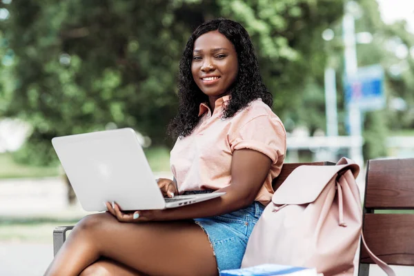 African student girl with laptop and books in city — Stock Photo, Image