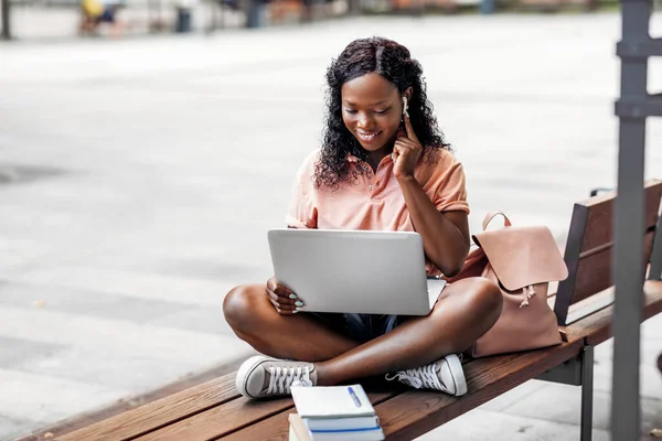 Menina estudante africano em fones de ouvido com laptop — Fotografia de Stock