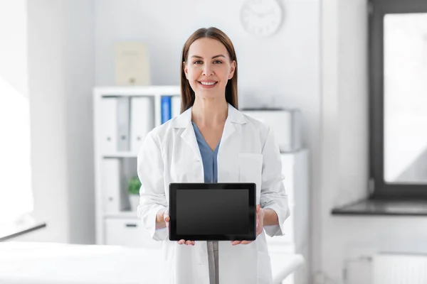 Smiling female doctor with tablet pc at hospital — Stok fotoğraf