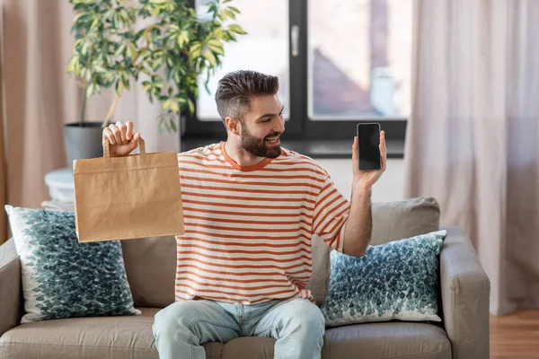 Smiling man using smartphone for food delivery — Foto de Stock