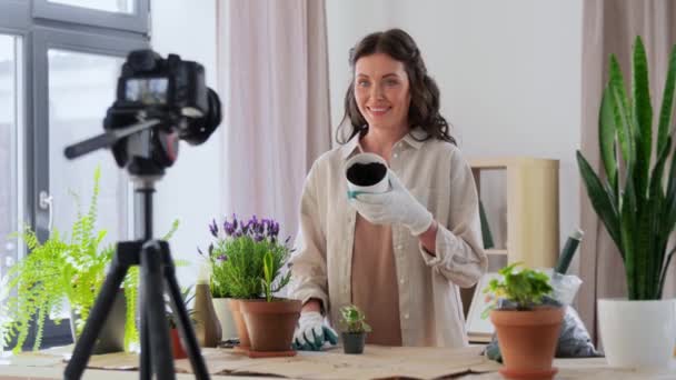 Happy woman or blogger planting flowers at home — Video Stock