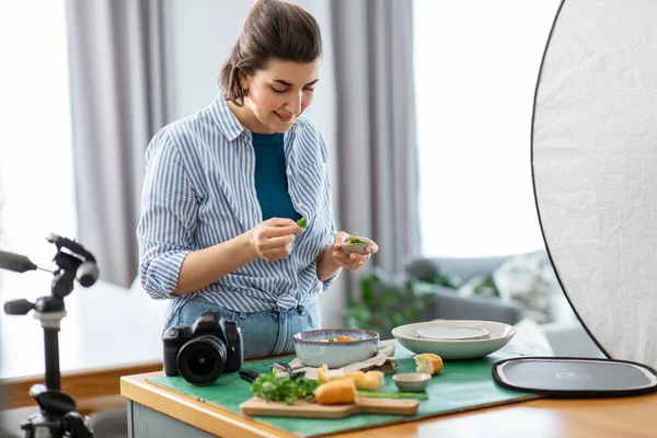 food photographer with camera working in kitchen