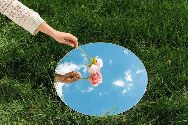 Natuurconcept Hand Met Pioenbloem Hemelspiegeling Ronde Spiegel Zomerveld — Stockfoto