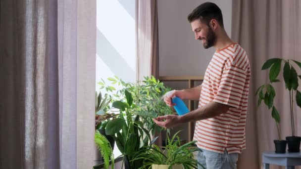People Nature Plants Care Concept Happy Smiling Man Spraying Houseplant — Stock Video