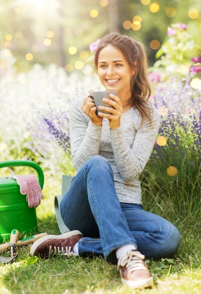 ガーデニングと人々の概念 夏の庭でお茶やコーヒーを飲む若い女性 — ストック写真