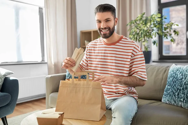 Consumption Eating People Concept Smiling Man Unpacking Takeaway Food Paper — Photo