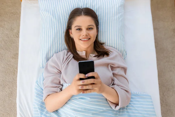 Mensen Bedtijd Rust Concept Gelukkig Lachend Tienermeisje Met Smartphone Liggend — Stockfoto
