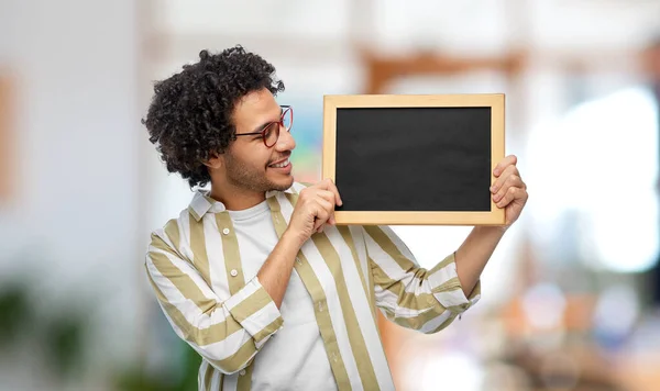 People Concept Smiling Young Man Glasses Holding Chalkboard Office Background — Stock fotografie