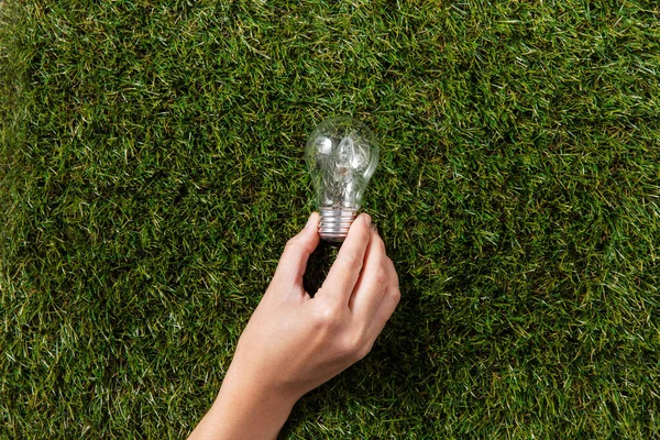 Electricity Energy Power Consumption Concept Close Hand Holding Lightbulb Green — Zdjęcie stockowe