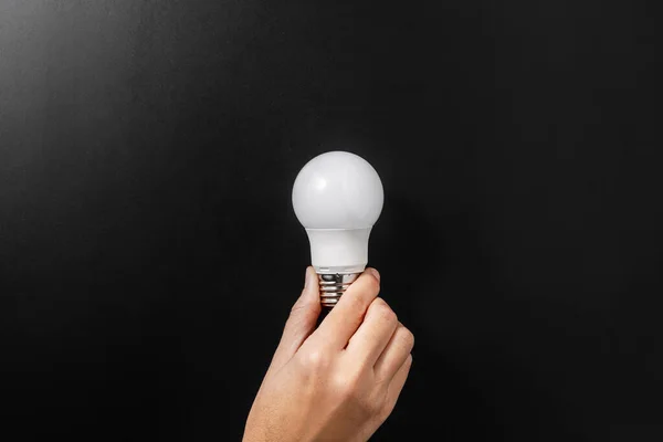 Electricity Energy Power Consumption Concept Close Hand Holding Lightbulb Black — Foto de Stock