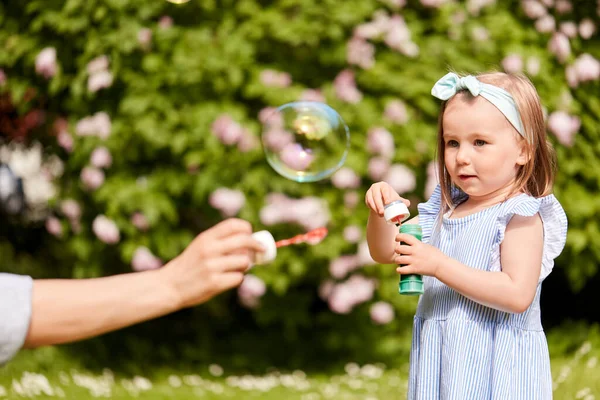 Childhood Leisure People Concept Happy Little Girl Blowing Soap Bubbles — Zdjęcie stockowe