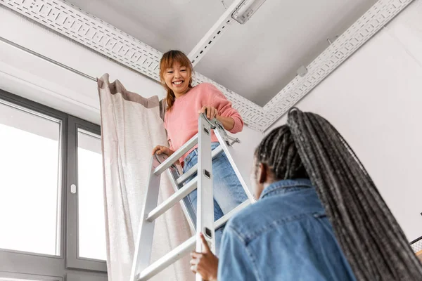 Improvement Renovation Concept Happy Smiling Women Ladder Hanging Curtains Home — Stockfoto