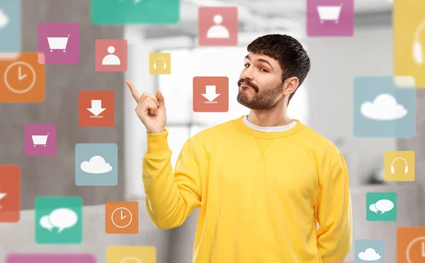 People Concept Young Man Yellow Sweatshirt Pointing Finger Something Mobile — Photo