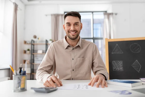 distance education, school and remote job concept - happy smiling male teacher having online class at home office