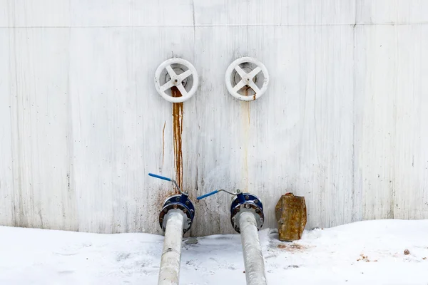 Ball valves and pipes on the tank wall. — Stock Photo, Image