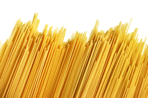 Uncooked Italian spaghetti on a white background. — Stock Photo, Image