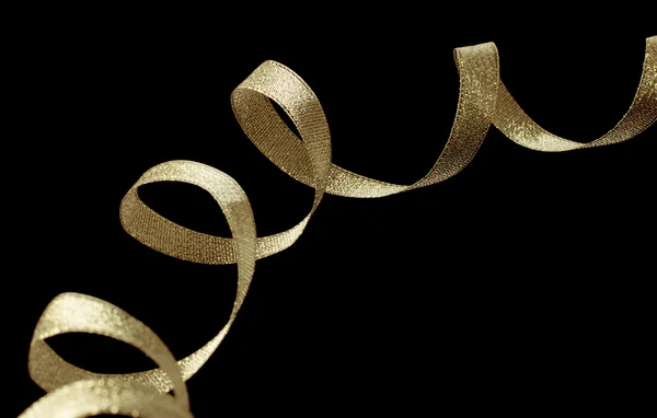 Gold ribbon ribbon on black background — Stock Photo, Image