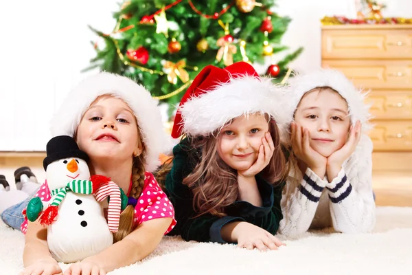 Kinder mit Weihnachtsmützen — Stockfoto