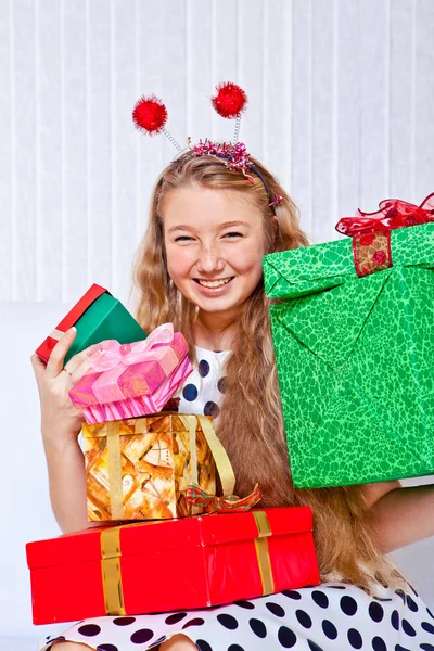 Laughing girl holding presents — Stock Photo, Image