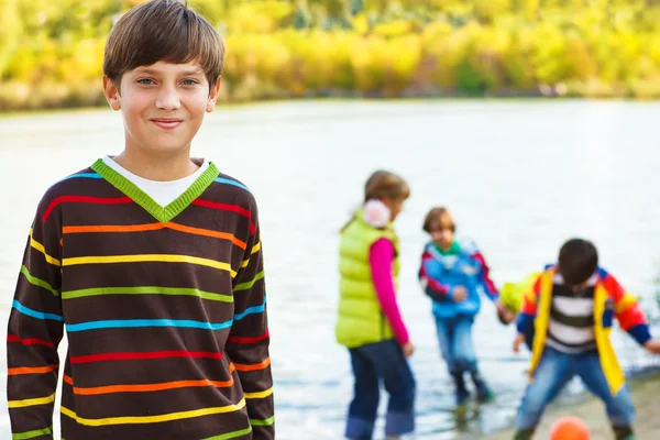 Smiling boy and his friends — Stock Photo, Image