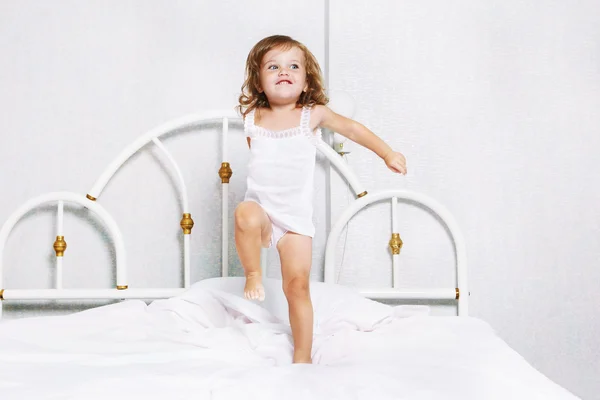 Toddler dancing in bed — Stock Photo, Image